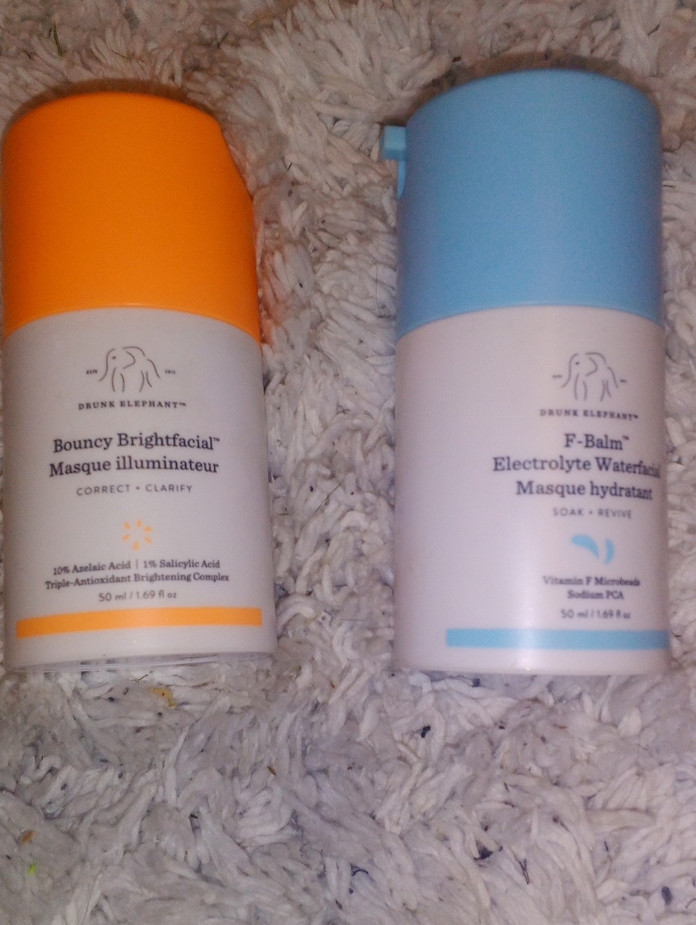Drunk Elephant Bouncy Brightfacial Masque with Orange Cap and Blue F-Balm Bottle